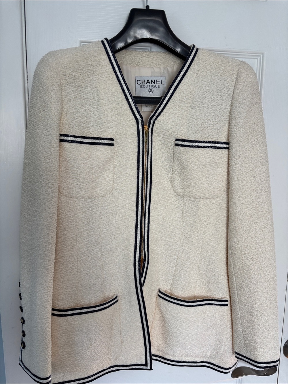 CHANEL Boutique Cream Bouclé Blazer with Black Trim Accents